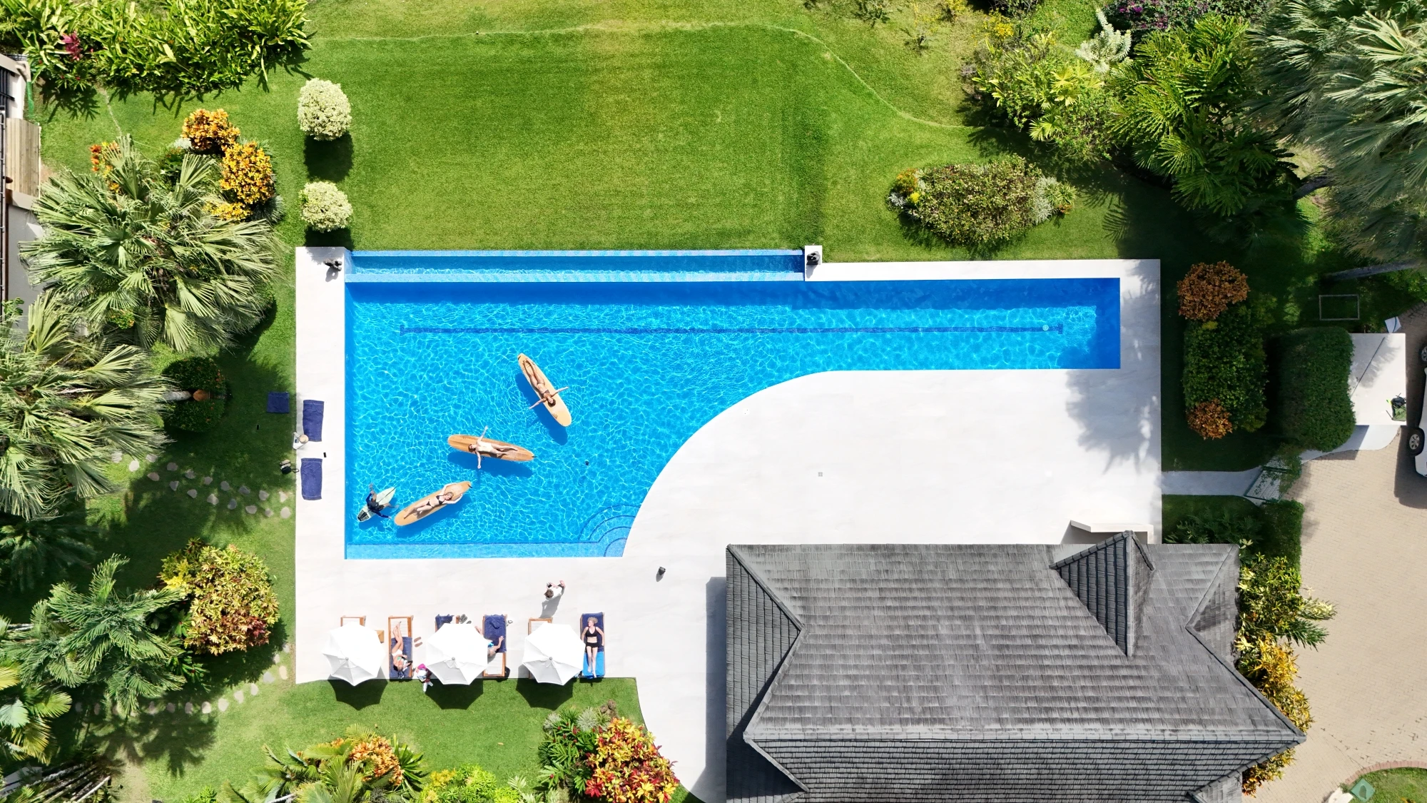 Aerial view of infinity pool with lounge chairs at Lamangata luxury villa resort in Manuel Antonio Costa Rica