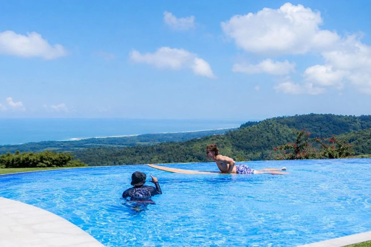 Surf lesson in infinity pool overlooking Costa Rica coastline