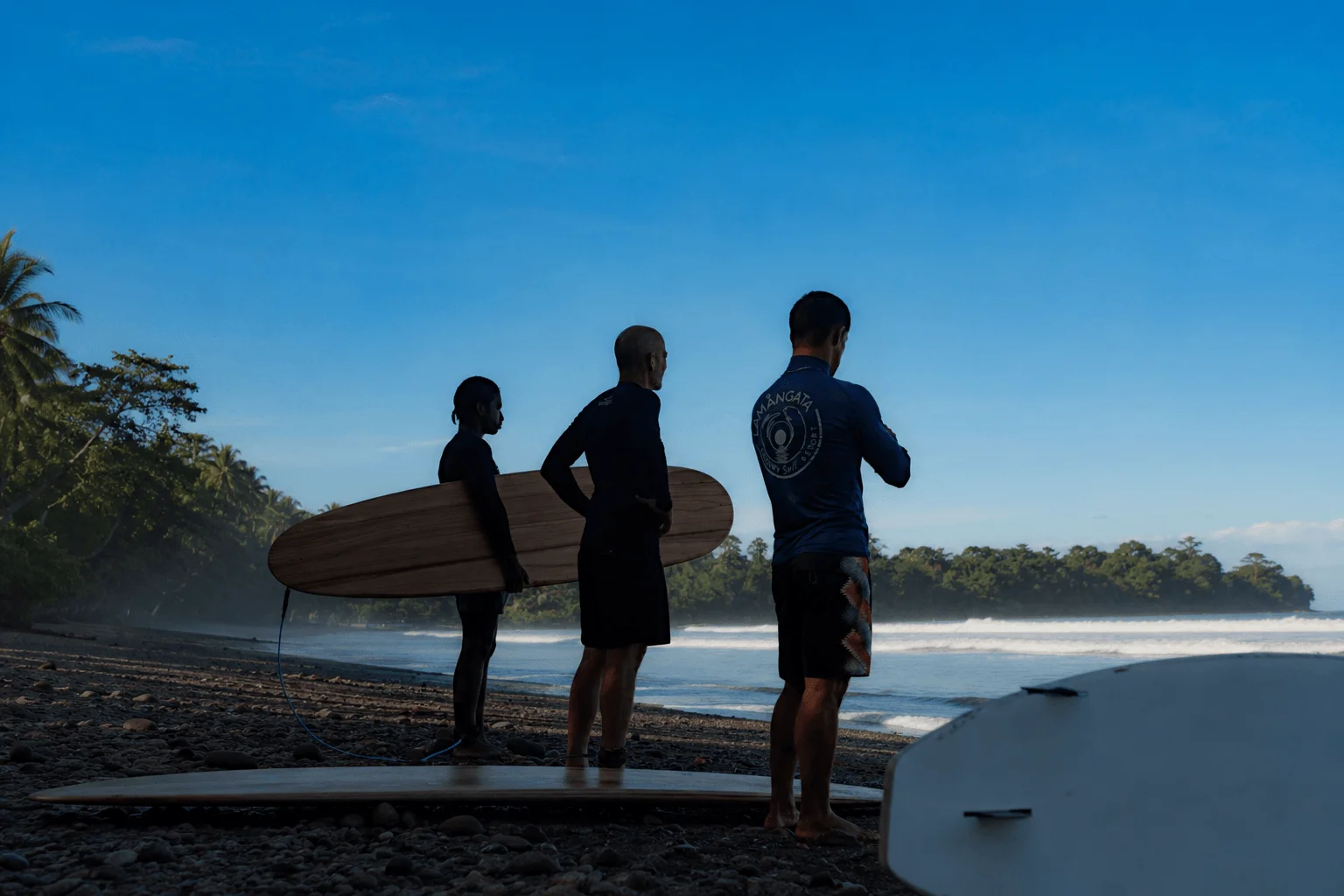 Surf coaches with boards overlooking Costa Rica beach