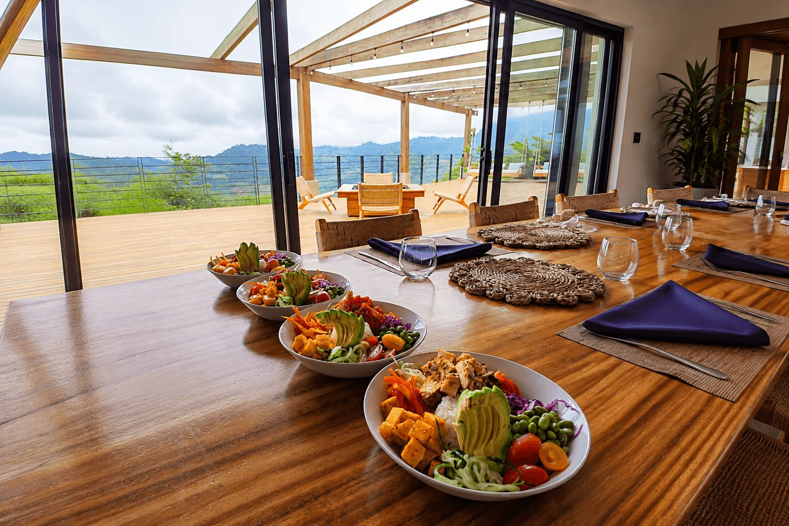 Fresh poke bowls plated on outdoor dining table with jungle view