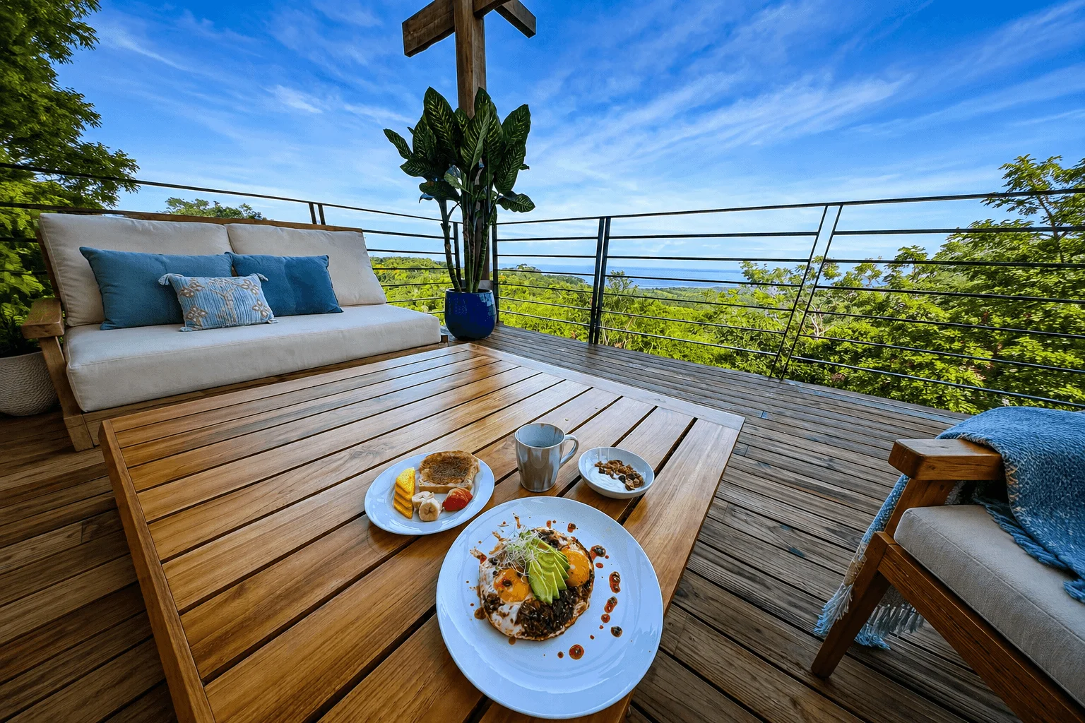 Breakfast plate on terrace table with ocean and jungle view